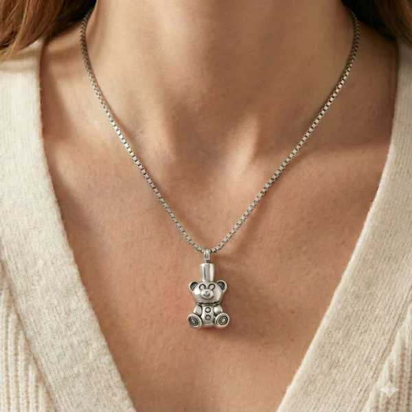 Woman wearing a stainless steel teddy bear cremation pendant (Model #109). Silver tone keepsake jewelry for ashes